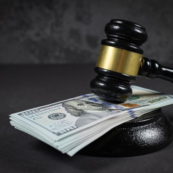 gavel on top of money stack