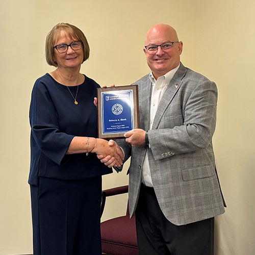Rebecca receiving the award from Pres. Doug Wareham