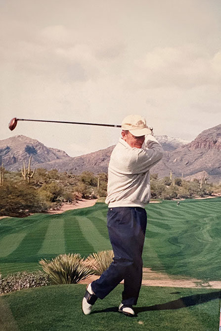 Jim on the golf course mid swing
