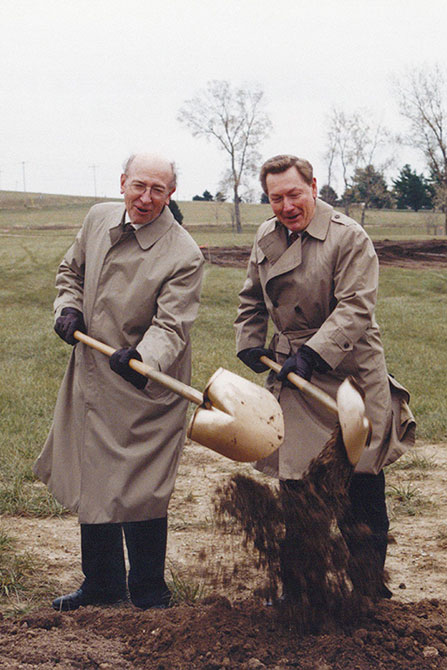 Jim and another man using shovels in a groundbreaking ceremony